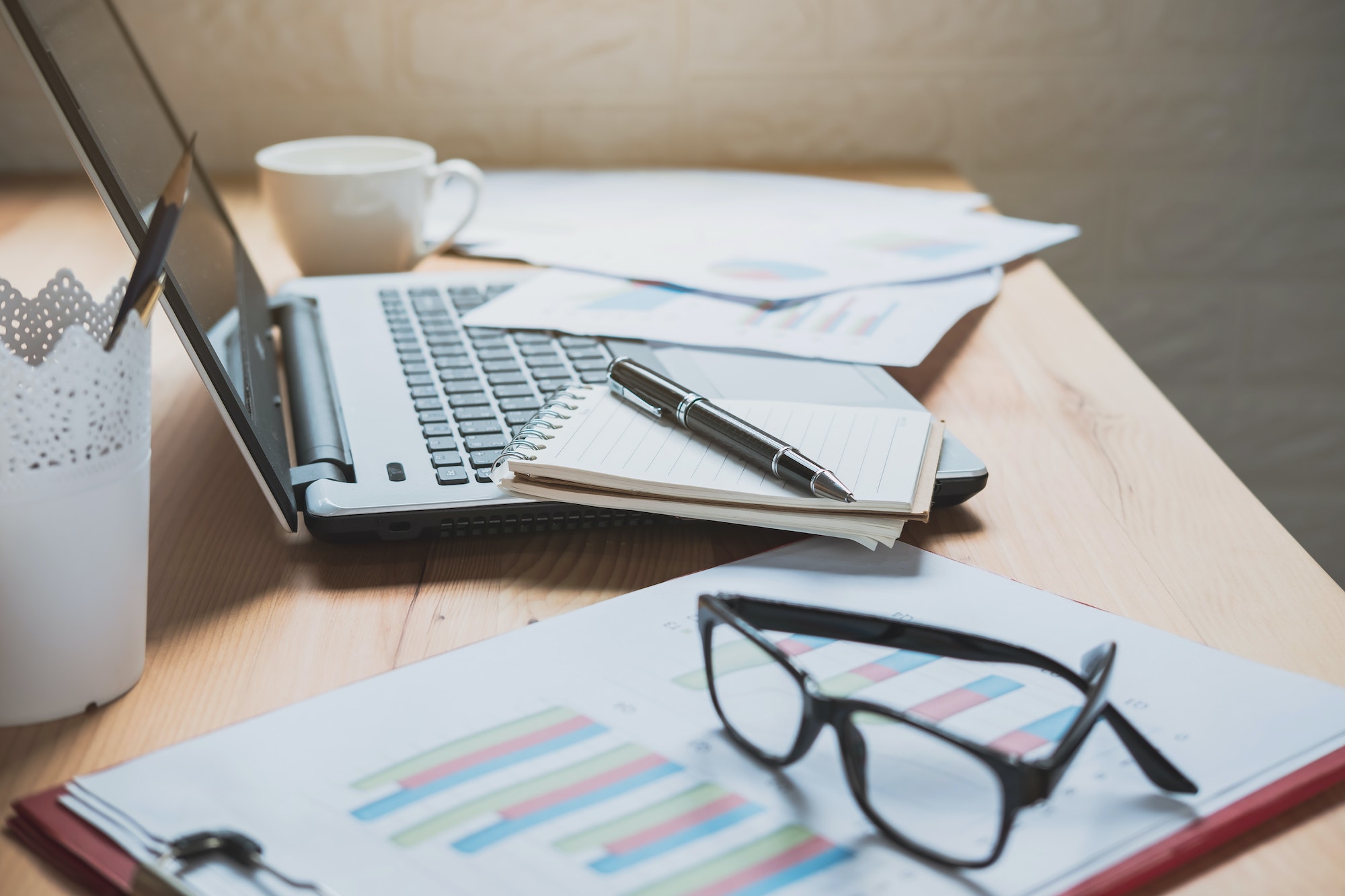 Desk office with marketing graph statistics analysis